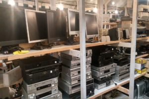 Shelves having Old Computer monitors, speakers, tape recorders, printers and wires