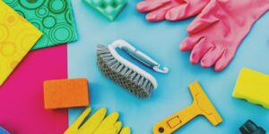 Household Items Removal Services | Junk-collector 1 cleaning brush, yellow and orange gloves also soap