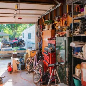 garage containing with old cycles, machine , baskets and  other things