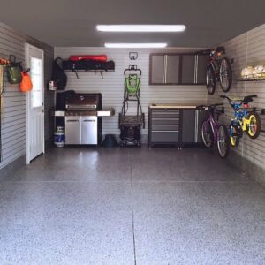 garage having bicycles on wall and some tables on corner of the garage